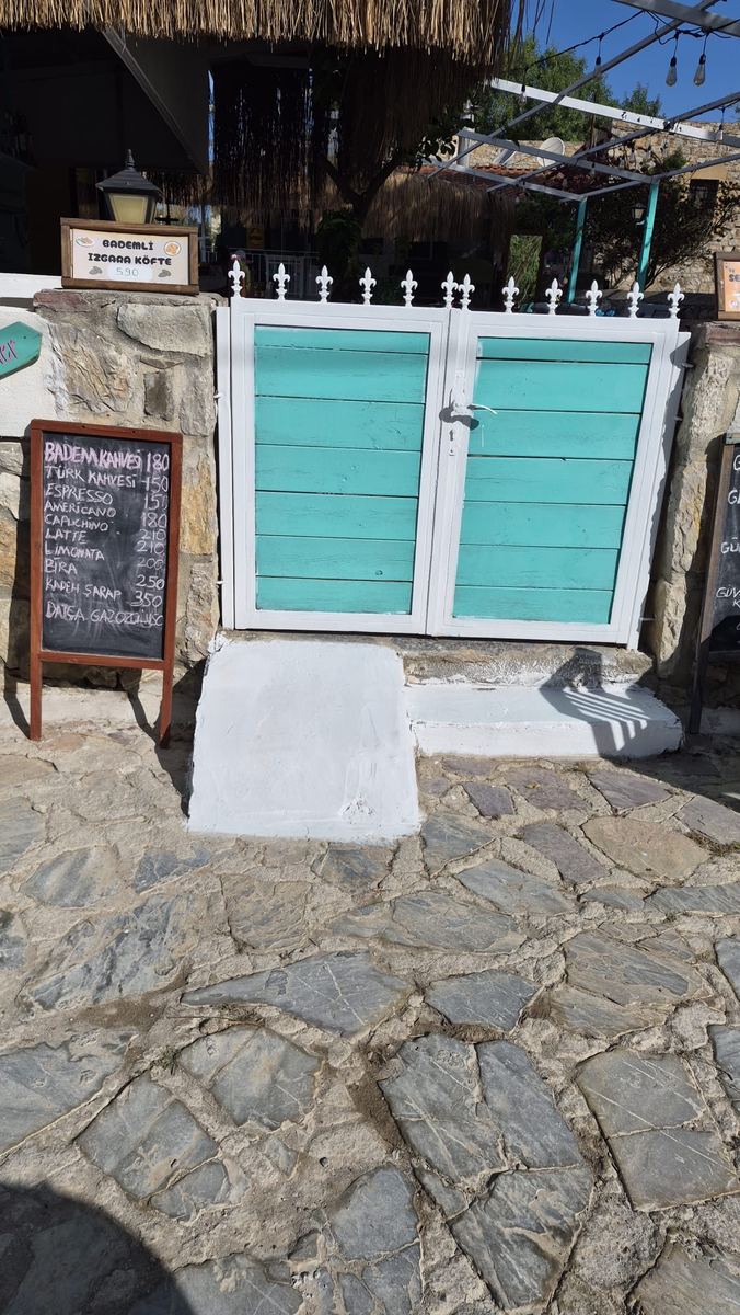 A white-painted access ramp added to a business entrance in the village