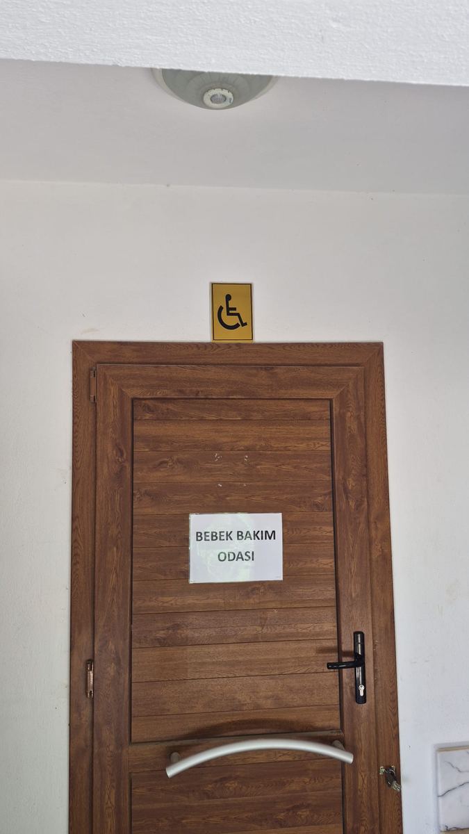 Toilet and baby-care room door marked with the international accessibility symbol